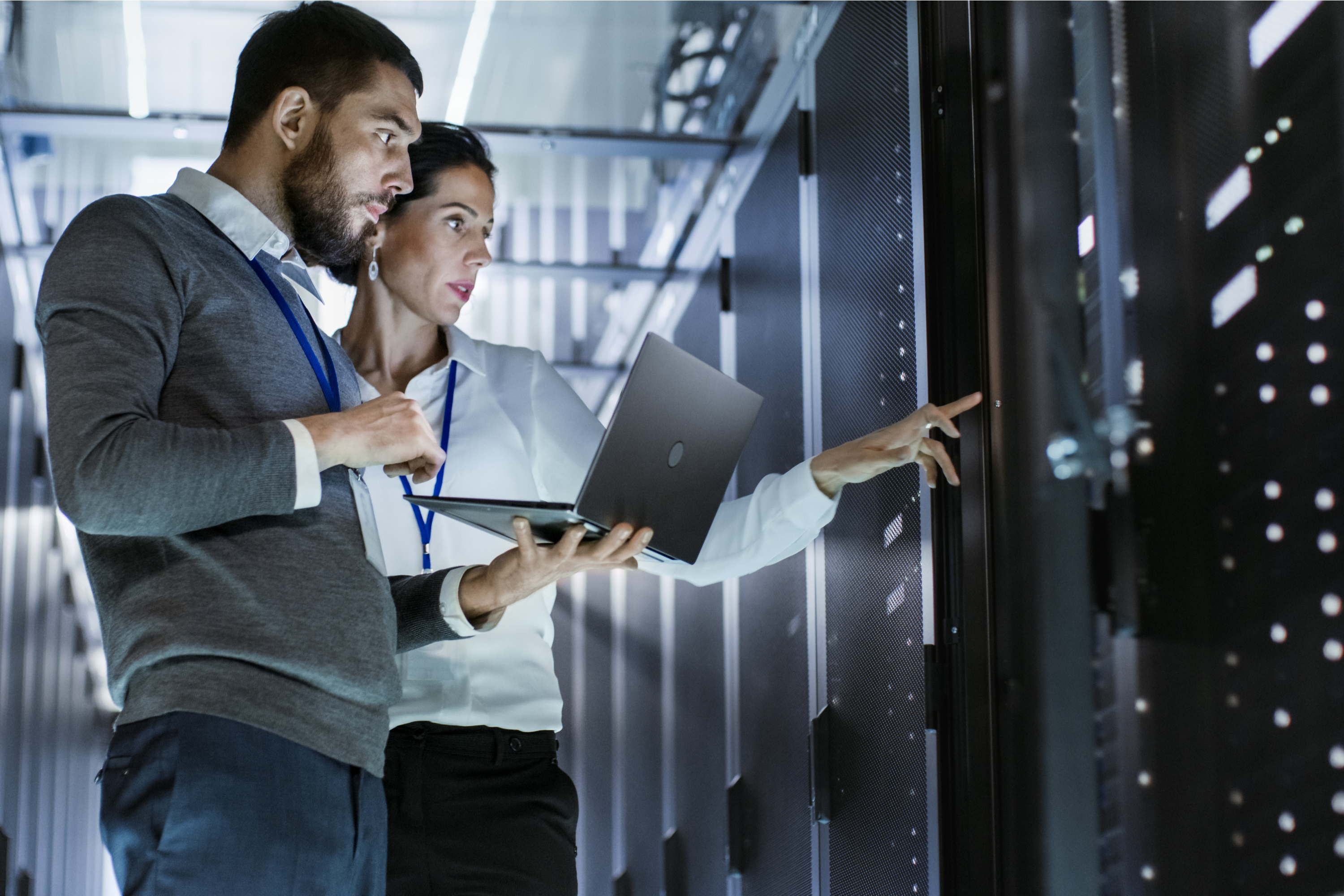 Man and woman working in data center