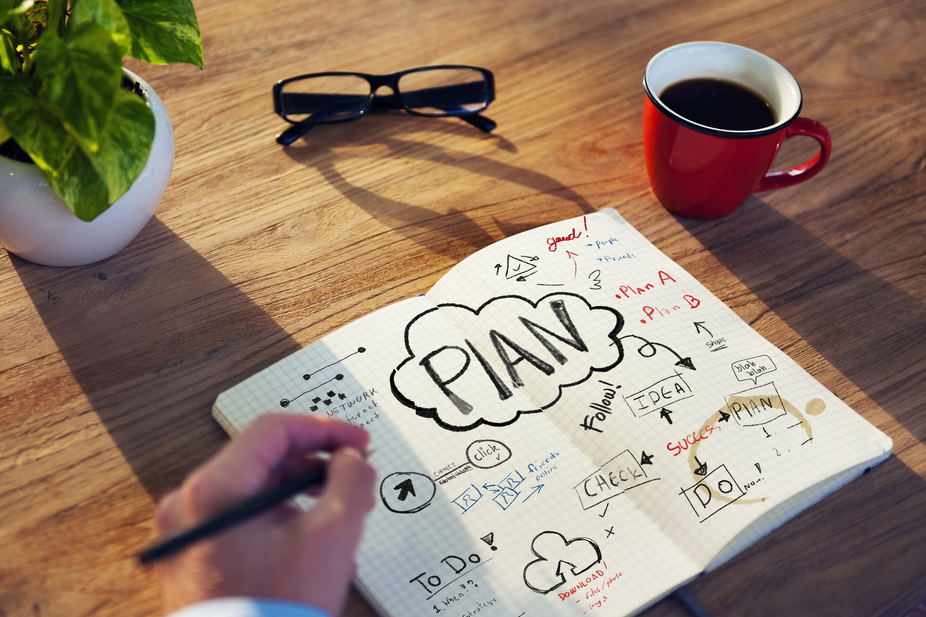 Man's hand drawing business plan graphic