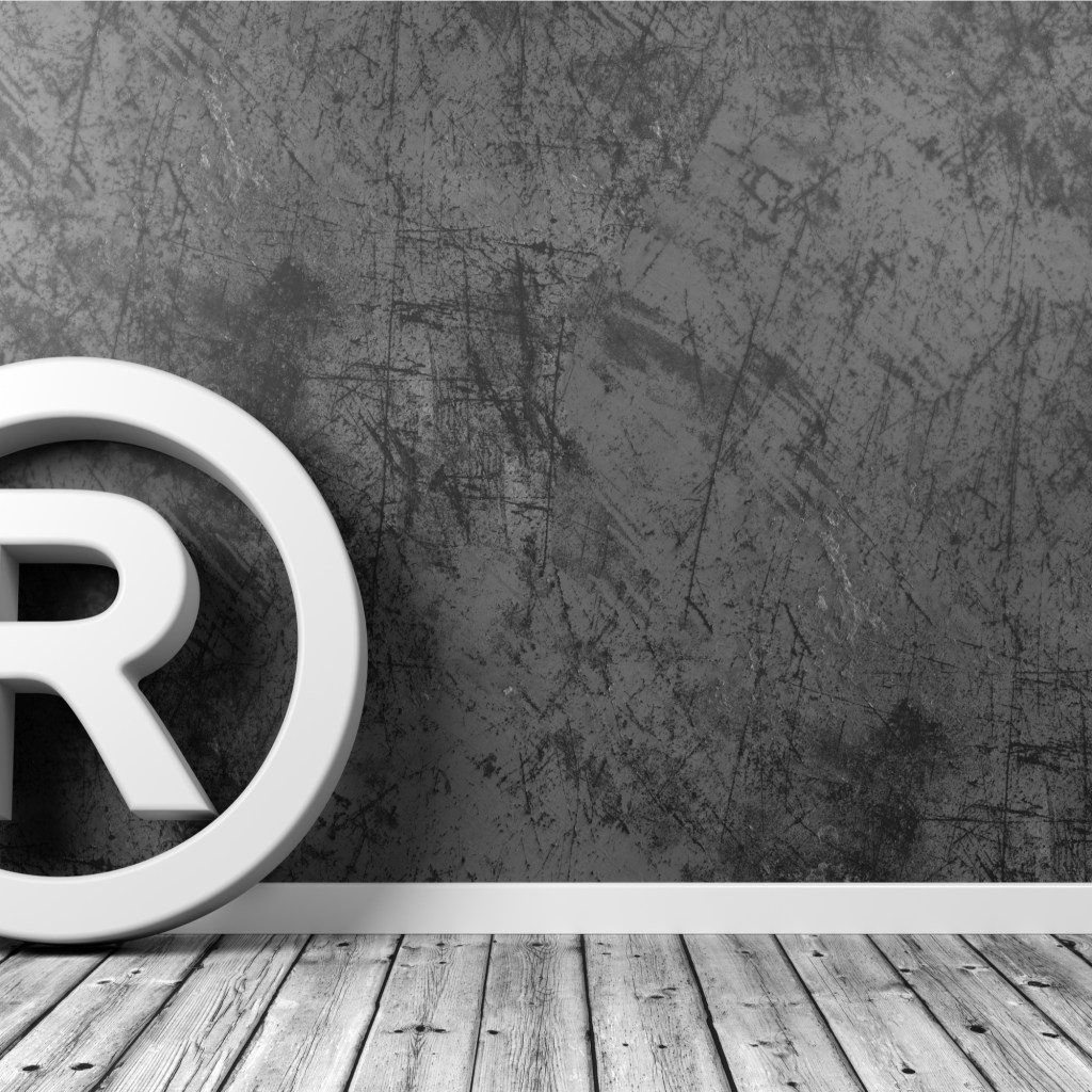 Symbol of registered trademark against the wall