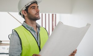 roofing business plan smart young caucasian man contractor  partner holding looking at the