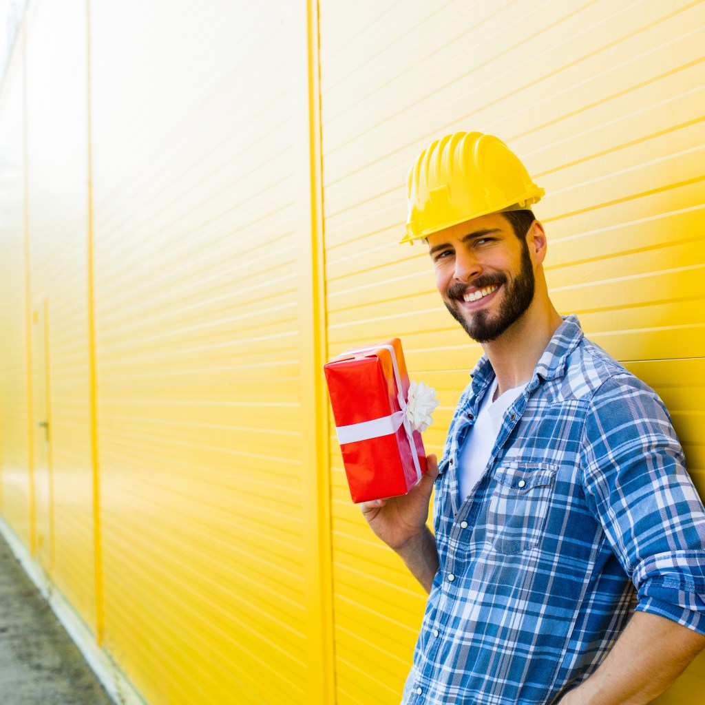 Happy contractor holding a gift