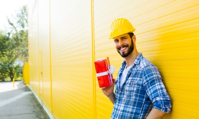 best gifts for a construction worker adult with yellow helmet and plaid shirt next to