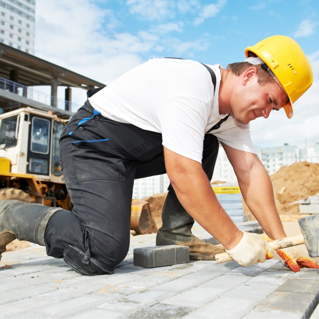 Construction worker hammering nails
