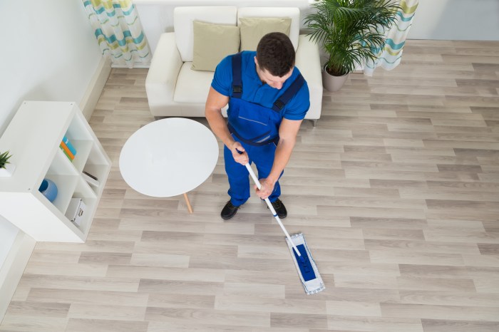 Overhead view of man cleaning the floor.