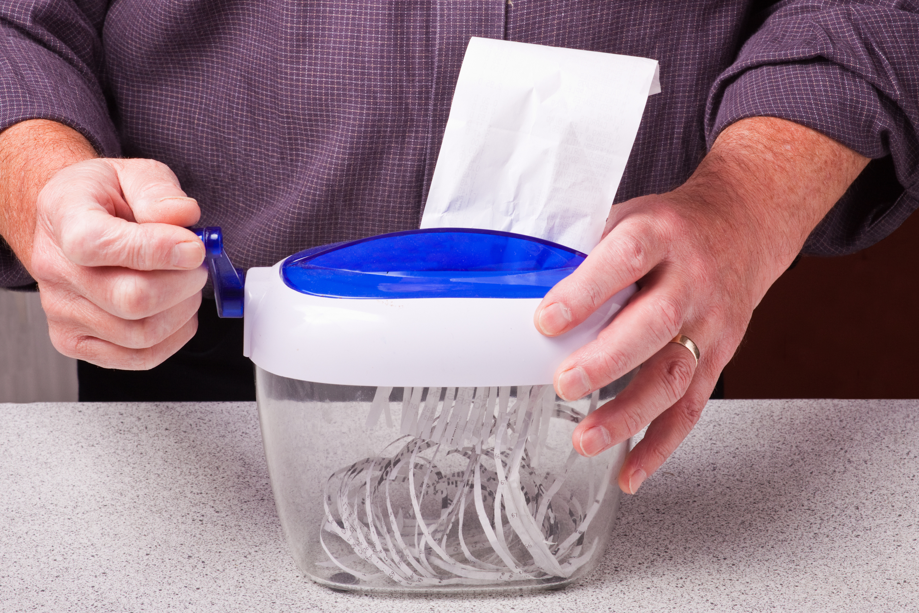 Person using a small paper shredder
