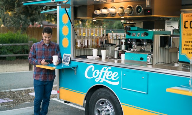 Customer drinking coffee by a food truck