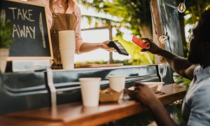 Customer making contactless payment at food truck