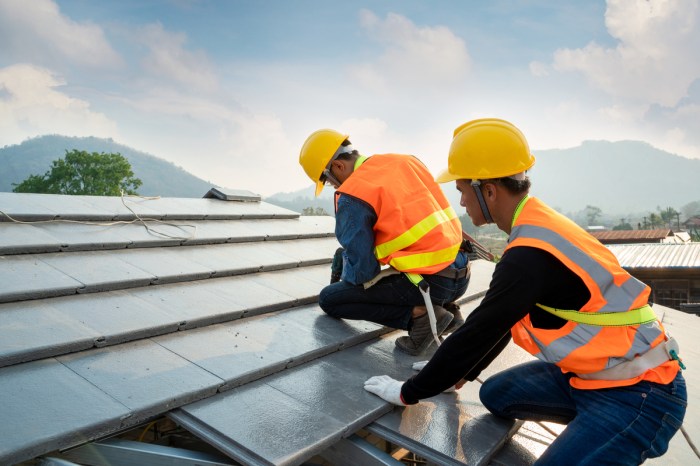 Workers installing a metal roof