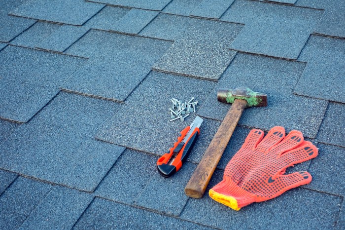 Hammer, nails, and glove on a roof