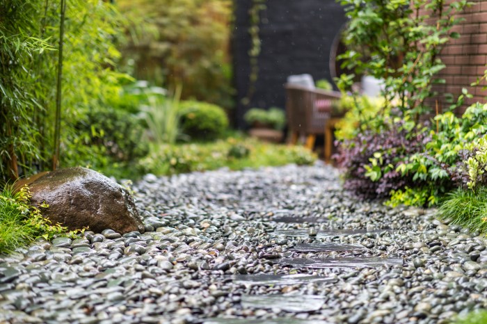 Decorative sprinkling of flowerbed paths with pebbles