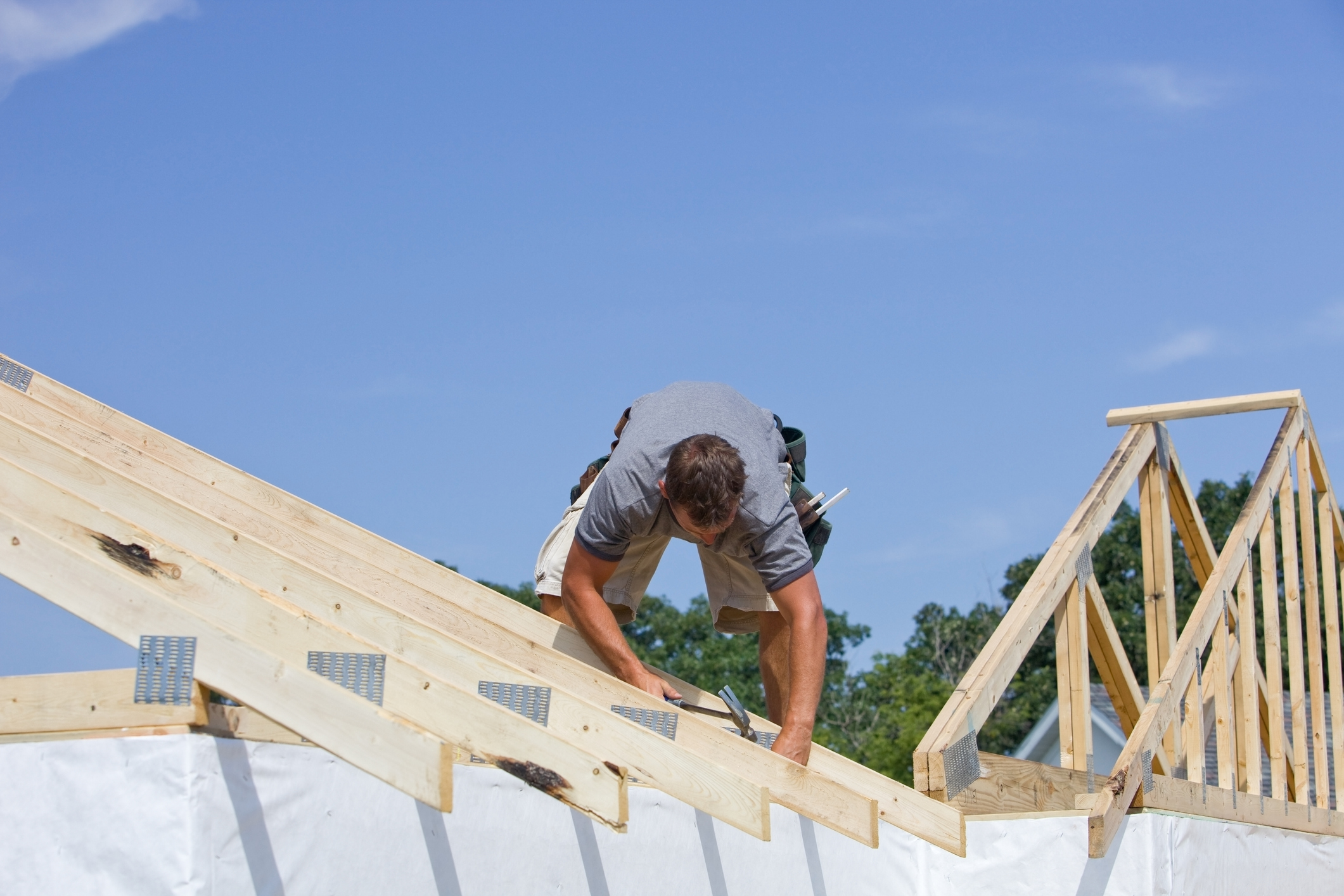 Worker building a roof truss