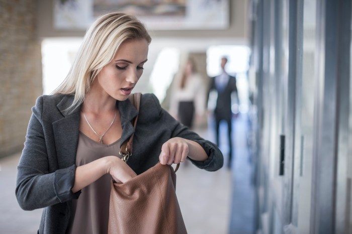 A businesswoman looks into her handbag