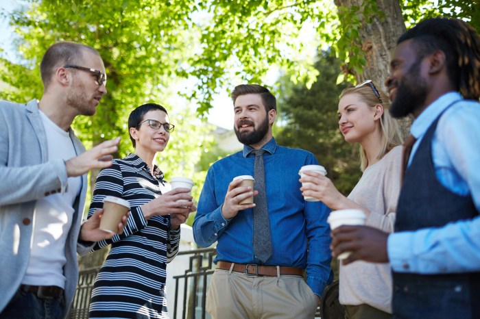 Five coworkers talk in an outdoor area