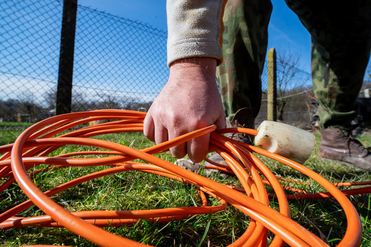 Gardener raising an extension cord