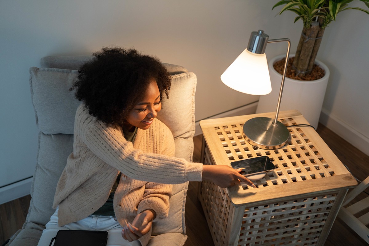 Woman putting her smartphone on wireless charger